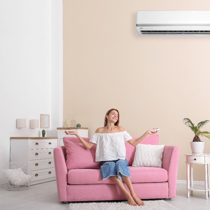 woman relaxing under an air conditioner