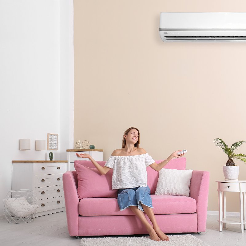 woman relaxing under an air conditioner