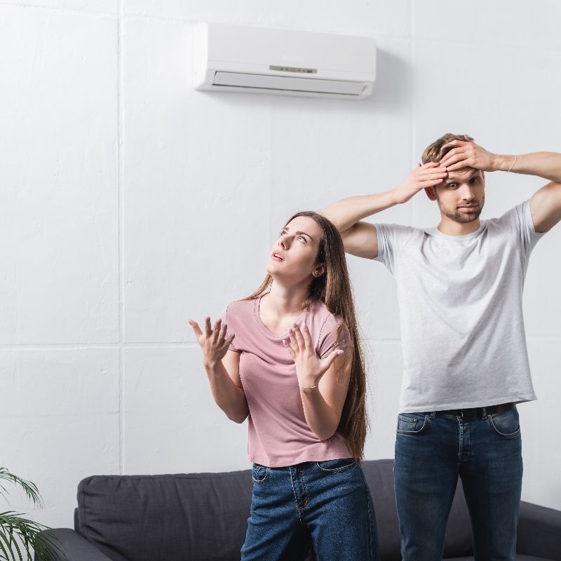 couple dealing with a broken air conditioner