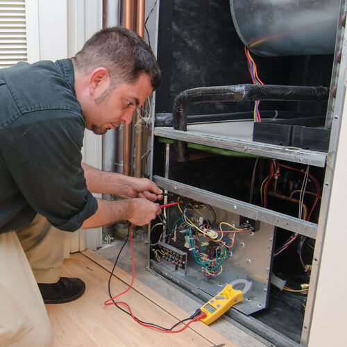 A Technician Services an HVAC System.