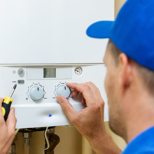 worker repairing a heating system