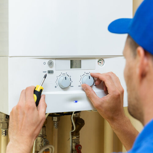 technician working on a home heating system