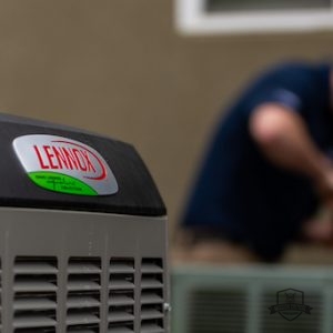 HVAC repairman installing Lennox air conditioner