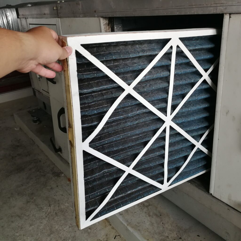 man replacing HVAC air filter