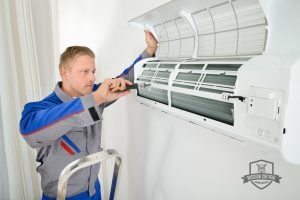 Man Completing Ductless Air Conditioning Repair Technician Completing Ductless Air Conditioning Repair